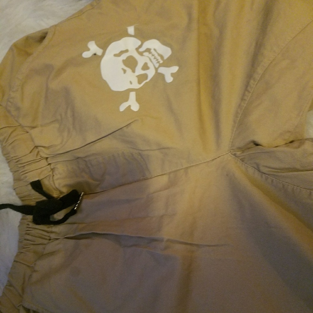 Cuffed pants. White skull. Great condition.